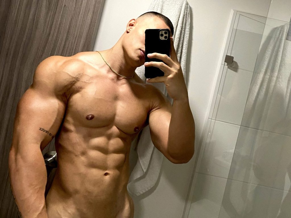 Gay cam stud Andrew Russell with cell phone